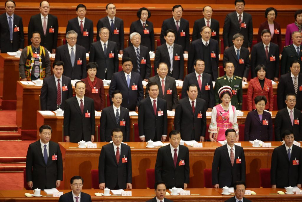 epa05195481 Chinese President Xi Jinping (front, L), Chinese Premier Li Keqiang (front, 2-L) along with government officials and delegates stand for the national anthem during the opening of the fourth Session of the 12th National People's Congress (NPC) at the Great Hall of the People in Beijing, China, 05 March 2016. The NPC has over 3,000 delegates and is the world's largest parliament or legislative assembly though its function is largely as a formal seal of approval for the policies fixed by the leaders of the Chinese Communist Party. EPA/HOW HWEE YOUNG